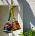 Introducing the Ceramic Bells Pair - expertly crafted and hand painted by skilled artisans. Made from high-quality ceramic material, these bells produce a clear and melodious sound that brings a touch of elegance to any space. Perfect for adding charm to your home decor or for unique gifts.