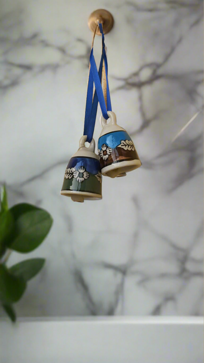 Introducing the Ceramic Bells Pair - expertly crafted and hand painted by skilled artisans. Made from high-quality ceramic material, these bells produce a clear and melodious sound that brings a touch of elegance to any space. Perfect for adding charm to your home decor or for unique gifts.