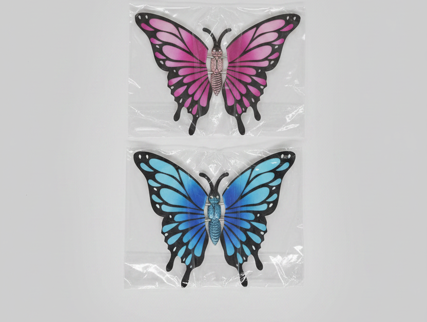 Two butterfly-shaped stickers, one pink and one blue, on a gray background.