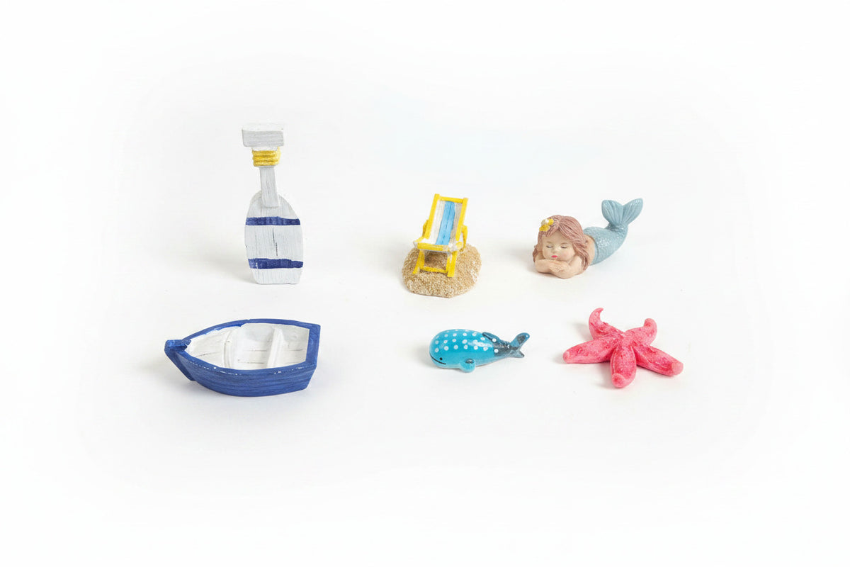 Colorful toy figurines of a bottle, beach chair, mermaid, boat, and starfish on a brown surface.